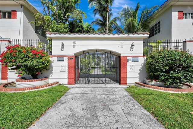 view of gate featuring a yard