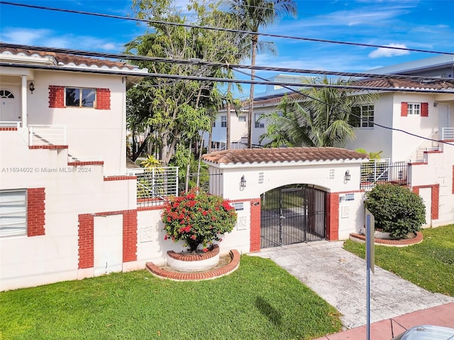 mediterranean / spanish-style house featuring a front yard