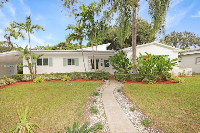 ranch-style home with a front yard and a carport