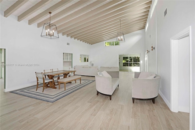 living room with beam ceiling, high vaulted ceiling, and light hardwood / wood-style flooring