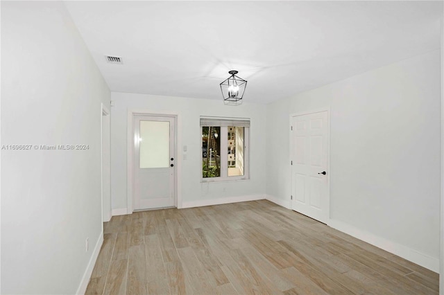 spare room with light hardwood / wood-style flooring