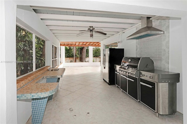 view of patio with an outdoor kitchen, ceiling fan, and area for grilling