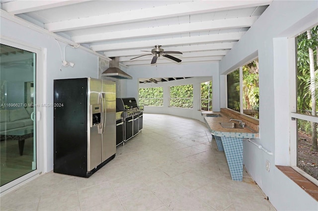 view of patio featuring ceiling fan, exterior kitchen, sink, and grilling area