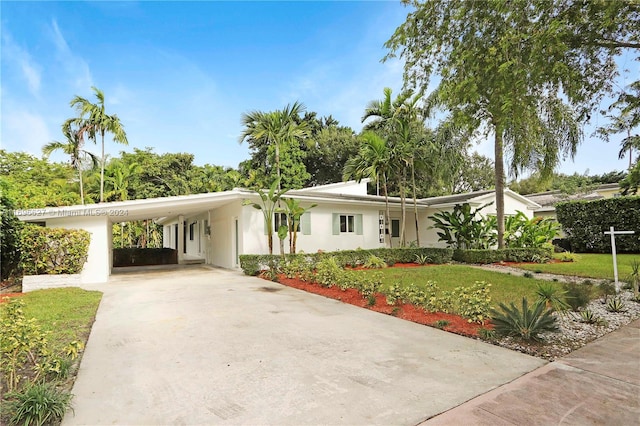 single story home with a carport and a front yard