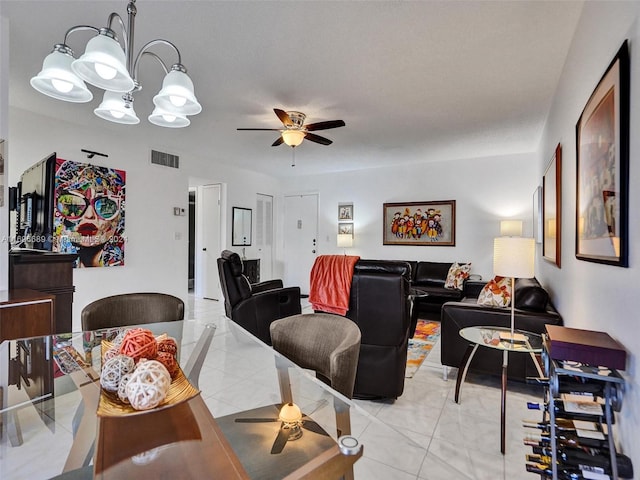 dining space with ceiling fan with notable chandelier