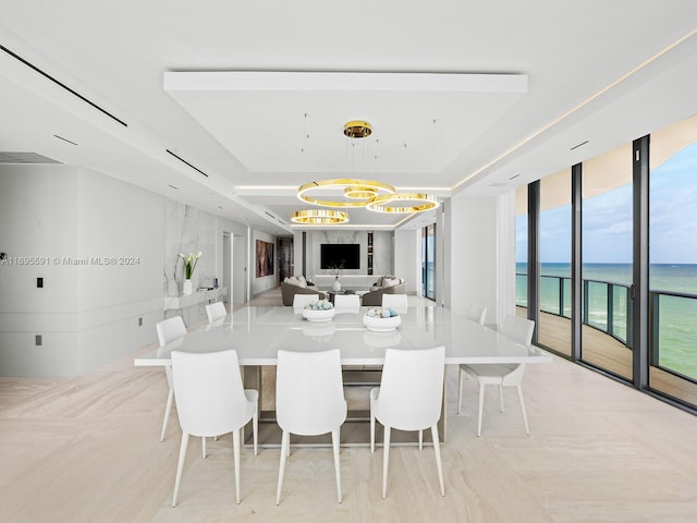 dining space featuring a water view and a high end fireplace