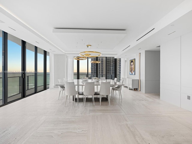 dining room with a chandelier and a water view