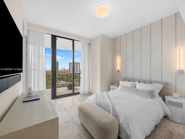 bedroom featuring light wood-type flooring and access to outside