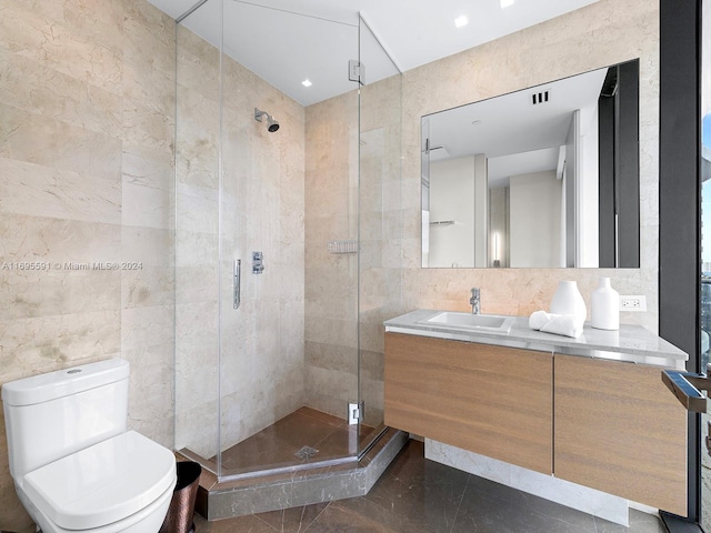 bathroom featuring tile patterned floors, an enclosed shower, vanity, tile walls, and toilet