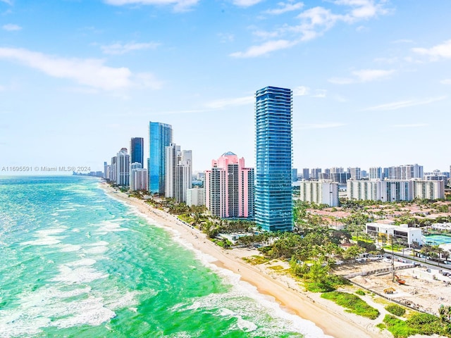 birds eye view of property with a beach view and a water view