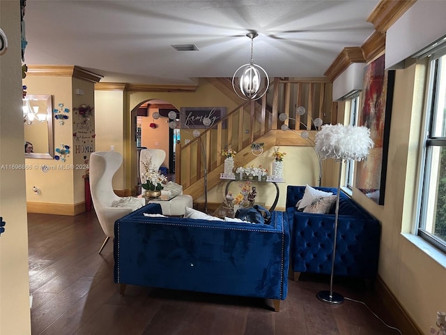 living room with a chandelier, dark hardwood / wood-style floors, plenty of natural light, and crown molding