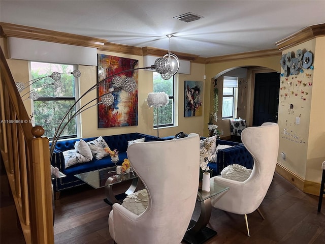 dining space with crown molding, dark wood-type flooring, and a notable chandelier