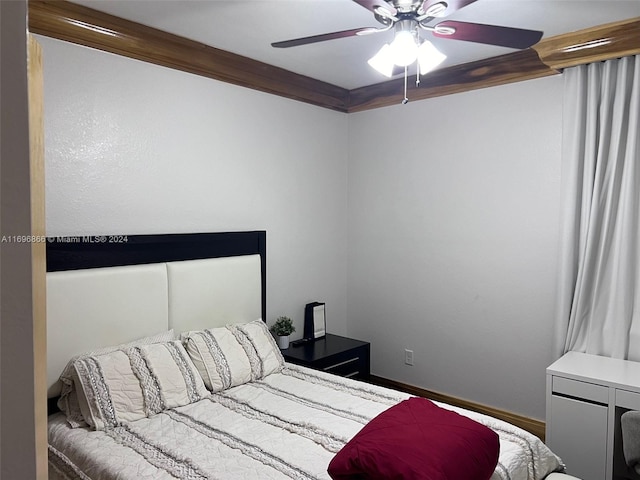 bedroom featuring ceiling fan and ornamental molding