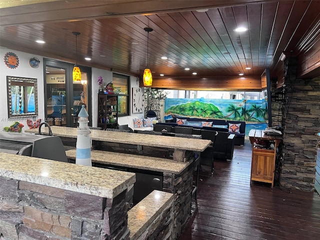 exterior space featuring light stone counters, wood ceiling, dark wood-type flooring, pendant lighting, and a kitchen island