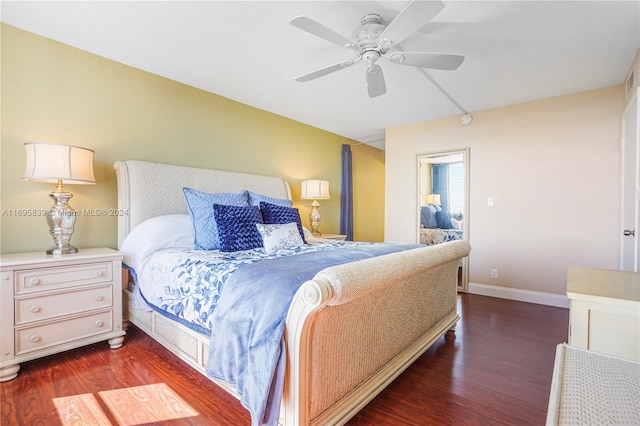 bedroom with ceiling fan and dark hardwood / wood-style flooring