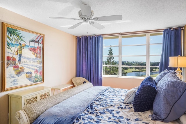 6921 Environ Blvd Unit 8N, Lauderhill, FL 33319 - bedroom featuring a textured ceiling, a ceiling fan, and a water view