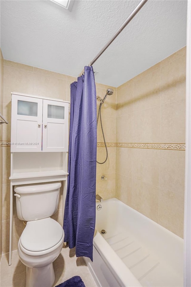 bathroom featuring a textured ceiling, shower / tub combo, tile walls, and toilet