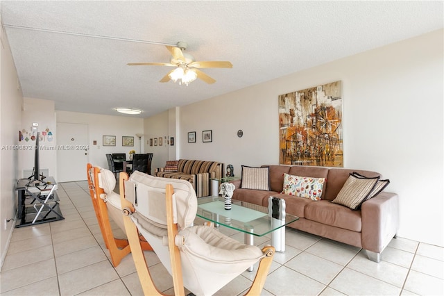 tiled living room featuring a textured ceiling and ceiling fan