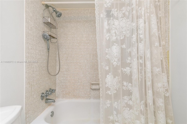 bathroom with shower / tub combo and toilet