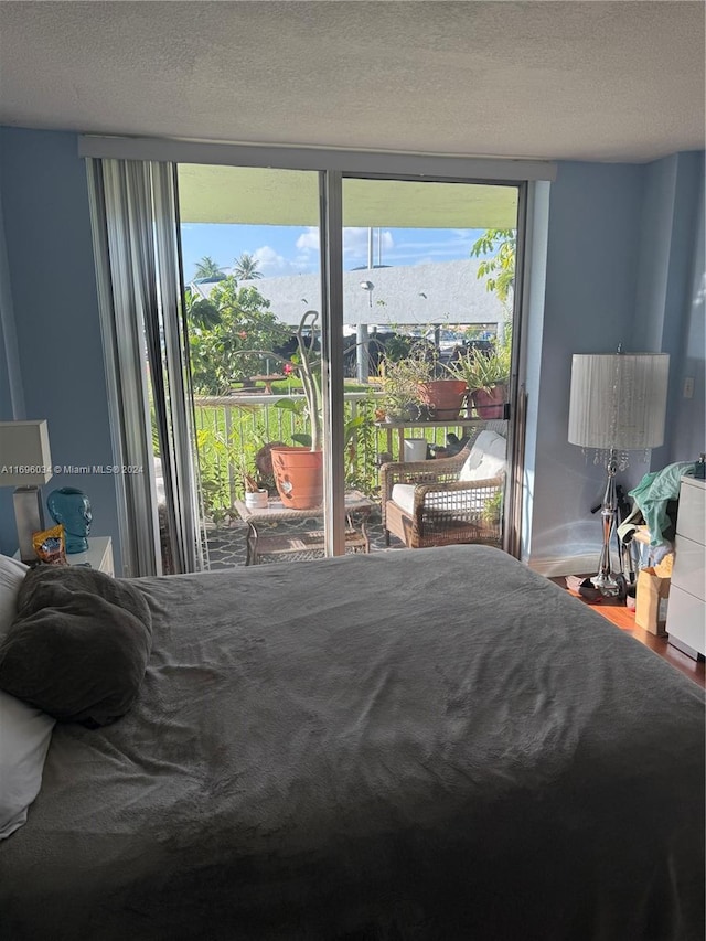 bedroom featuring a textured ceiling and access to outside