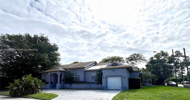 ranch-style house with a front lawn and a garage