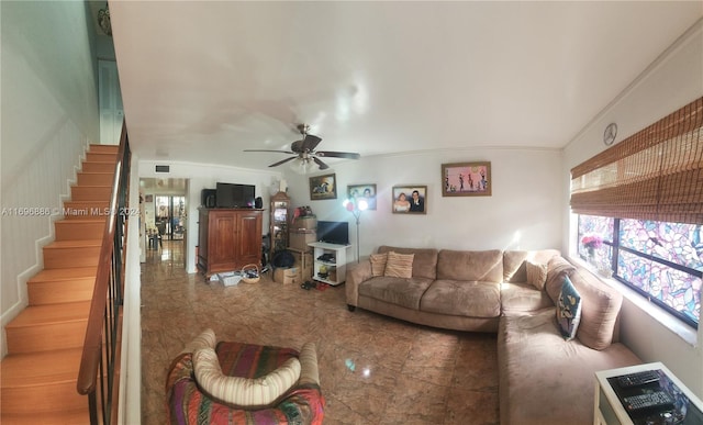 living room with crown molding and ceiling fan