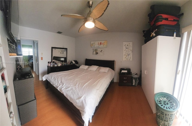 bedroom featuring wood-type flooring, ceiling fan, and lofted ceiling