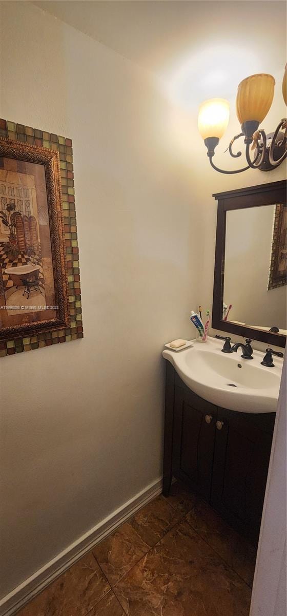 bathroom with vanity and a notable chandelier