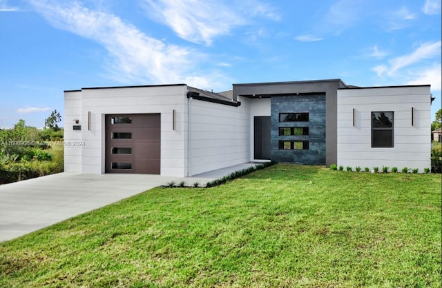 modern home with a garage and a front lawn