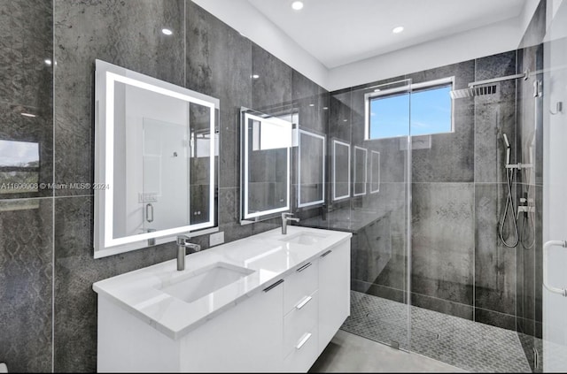 bathroom with vanity and a shower with door