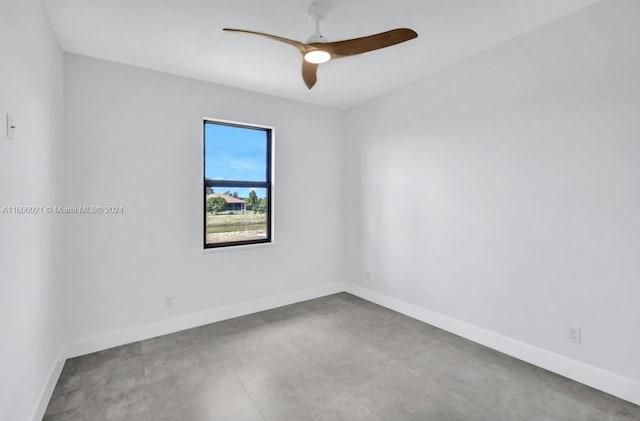 empty room with ceiling fan and concrete floors