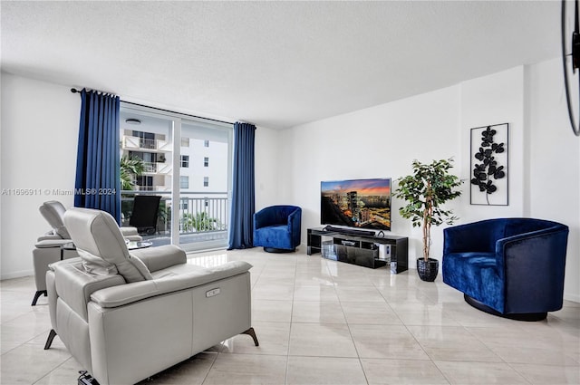 living room featuring floor to ceiling windows, light tile patterned floors, and a textured ceiling