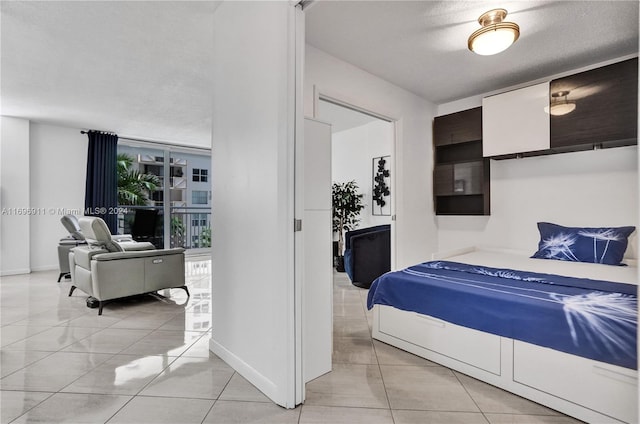 bedroom with light tile patterned flooring and a textured ceiling