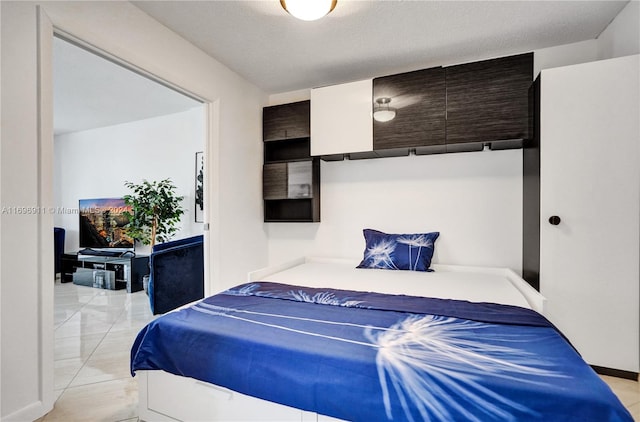 tiled bedroom featuring a textured ceiling