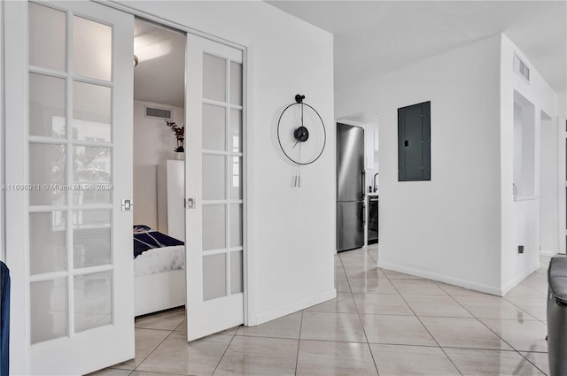 hallway with light tile patterned floors and electric panel