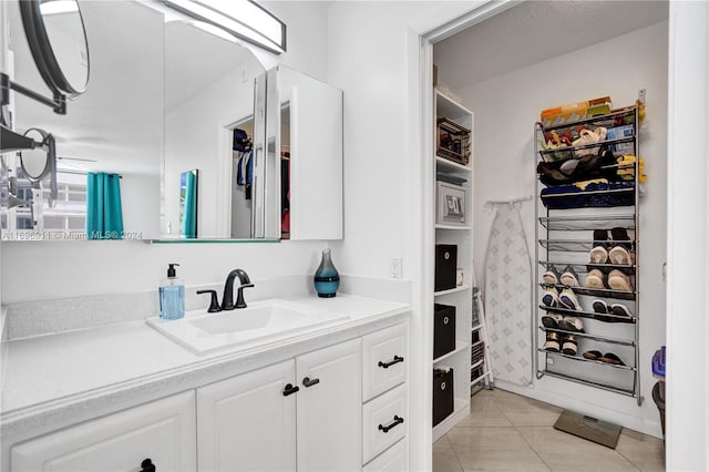 bathroom featuring tile patterned flooring and vanity