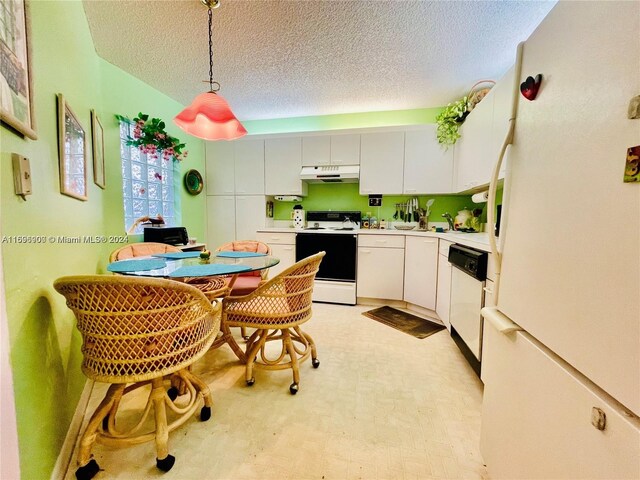 kitchen featuring a textured ceiling, white appliances, decorative light fixtures, and white cabinetry