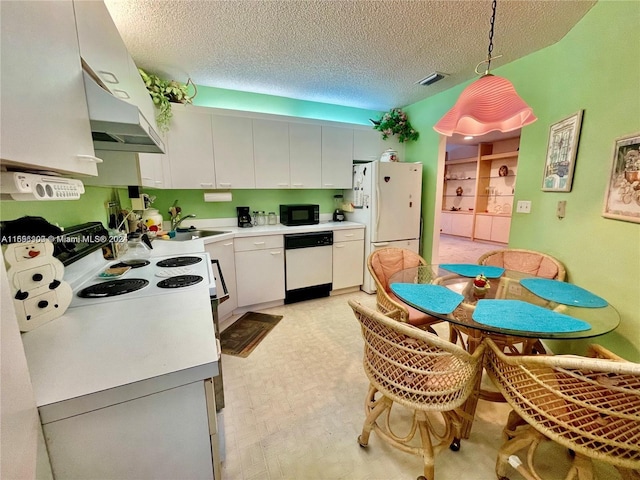 kitchen with white cabinets, a textured ceiling, white appliances, and decorative light fixtures