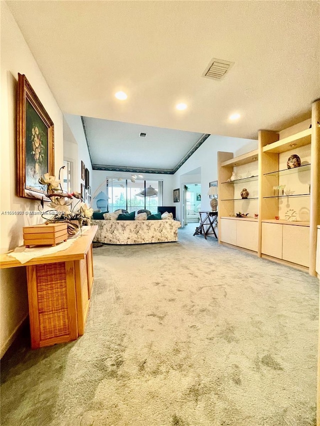 sitting room featuring a textured ceiling, carpet, and lofted ceiling