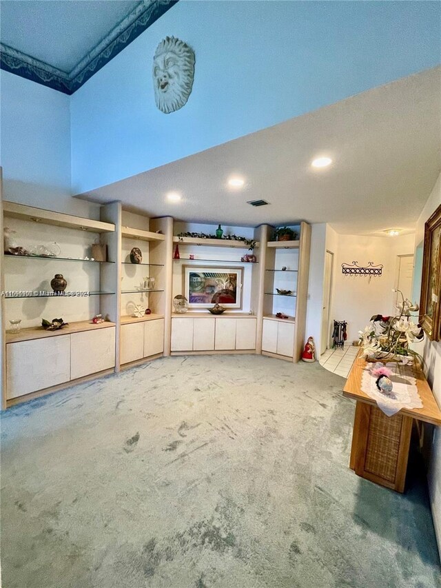 unfurnished living room with carpet and a textured ceiling