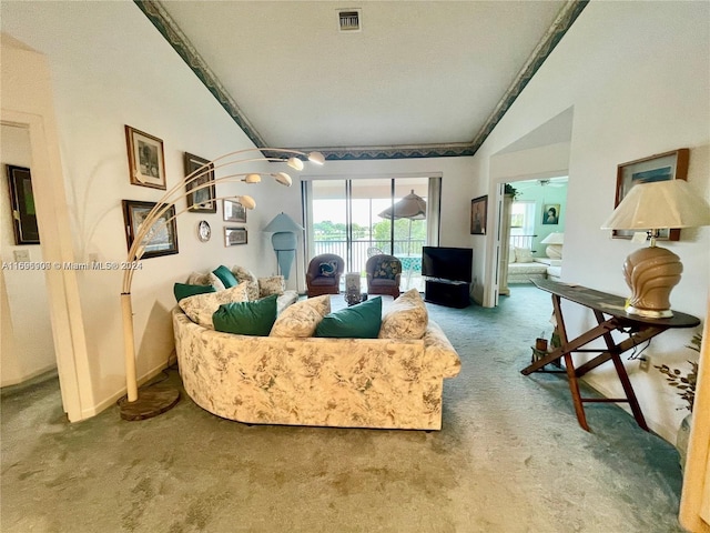 carpeted living room featuring a textured ceiling, ceiling fan, and vaulted ceiling