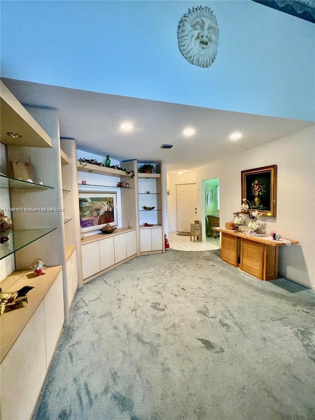 carpeted living room with a textured ceiling