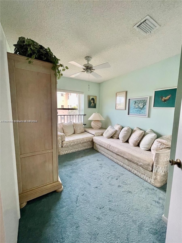 unfurnished living room with carpet, a textured ceiling, and ceiling fan