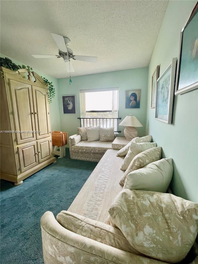 carpeted living room with ceiling fan and a textured ceiling