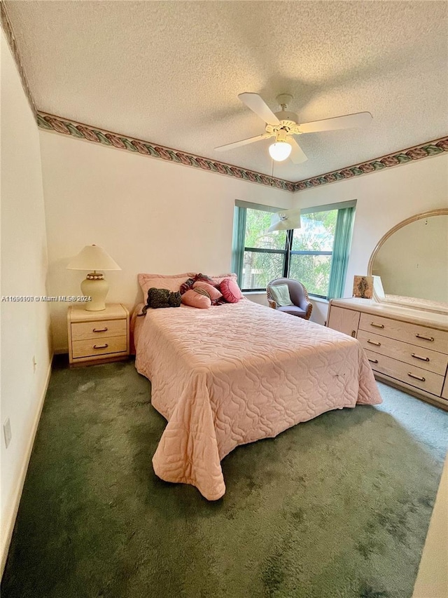 bedroom with a textured ceiling, dark carpet, and ceiling fan