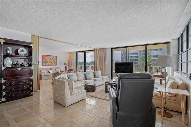 living room featuring a wall of windows, a textured ceiling, and a wealth of natural light