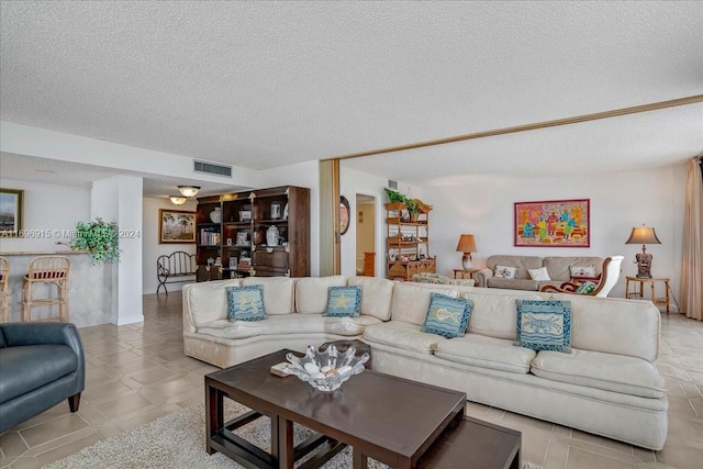 tiled living room with a textured ceiling