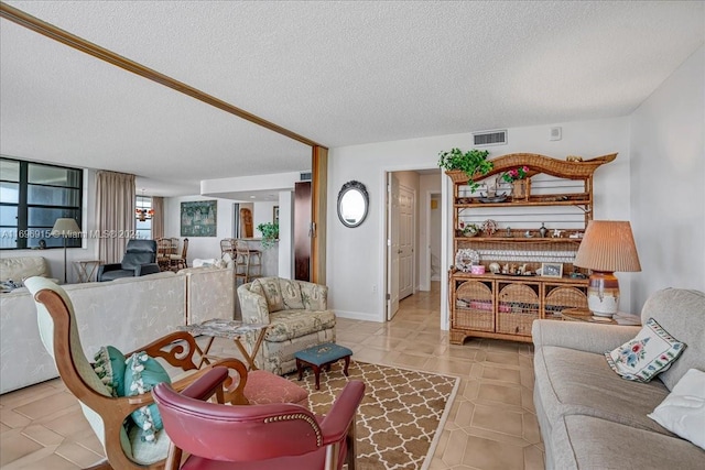 tiled living room featuring a textured ceiling