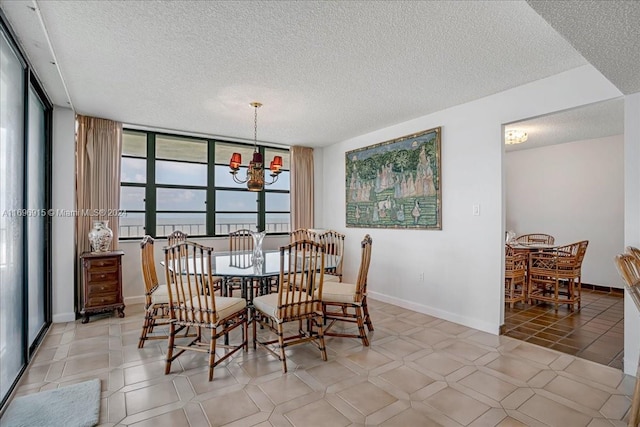 tiled dining area with a textured ceiling, floor to ceiling windows, and a notable chandelier