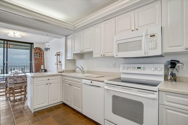 kitchen with kitchen peninsula, white appliances, white cabinetry, and sink